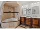 Luxurious bathroom featuring a walk-in tiled shower, soaking tub, and and vanity sinks at 5342 S Halifax Cir, Centennial, CO 80015