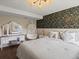 Stylish bedroom features a hanging chair, vanity, and elegant floral accent wall at 5342 S Halifax Cir, Centennial, CO 80015