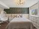 Charming bedroom with unique lighting, modern accent wall, white furniture, and a hanging chair at 5342 S Halifax Cir, Centennial, CO 80015