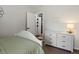 Cozy bedroom featuring a white dresser, soft green bedding, and neutral décor at 5342 S Halifax Cir, Centennial, CO 80015