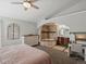 Spacious bedroom featuring a ceiling fan, large soaking tub and shower, and a built-in desk area at 5342 S Halifax Cir, Centennial, CO 80015