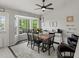 Bright dining area with bay window, ceiling fan and wood table for six at 5342 S Halifax Cir, Centennial, CO 80015