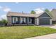 Charming home exterior with stone accents, white trim, and a manicured lawn at 5342 S Halifax Cir, Centennial, CO 80015