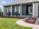 Inviting front porch with rocking chairs, decorative plants, and a well-maintained lawn at 5342 S Halifax Cir, Centennial, CO 80015