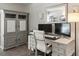 Dedicated home office with built-in storage, modern desk, and computer setup at 5342 S Halifax Cir, Centennial, CO 80015