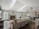 Sunlit living room with fireplace, skylights, and open floor plan to the kitchen at 5342 S Halifax Cir, Centennial, CO 80015
