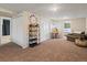 Spacious living room area with neutral walls, carpet flooring, a desk with chair, and 2 large closets at 5342 S Halifax Cir, Centennial, CO 80015