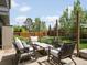 The spacious patio includes comfortable seating, a fire pit, and string lights at 5342 S Halifax Cir, Centennial, CO 80015