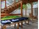 Covered patio area with cushioned bench seating and a hanging swing, creating a relaxing outdoor space at 5342 S Halifax Cir, Centennial, CO 80015