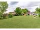 Large, green backyard with a wooden playset and a gazebo, great for Gathering fun and entertaining at 10478 Ogden St, Northglenn, CO 80233