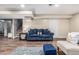Finished basement featuring a comfortable seating area, staircase, and wood-look flooring at 10478 Ogden St, Northglenn, CO 80233