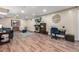 Finished basement offering a living area with a fireplace, TV, desk area, and wood-look flooring at 10478 Ogden St, Northglenn, CO 80233