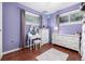 Charming bedroom featuring a vanity area, hardwood floors, and soft colors at 10478 Ogden St, Northglenn, CO 80233