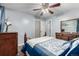 Bedroom with hardwood floors, a ceiling fan, and a coordinating wooden dresser and mirror at 10478 Ogden St, Northglenn, CO 80233