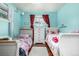 Shared bedroom with two beds, hardwood floors, and colorful decor at 10478 Ogden St, Northglenn, CO 80233