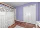 Comfortable bedroom with hardwood floors, a bed with a wooden frame, and ample closet space at 10478 Ogden St, Northglenn, CO 80233