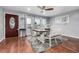 Bright dining room featuring hardwood floors, neutral paint, modern light fixture and large windows at 10478 Ogden St, Northglenn, CO 80233
