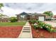 Inviting brick home boasts a well-manicured lawn and garden, solar panels and an attached garage at 10478 Ogden St, Northglenn, CO 80233