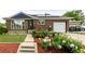 Charming brick home with solar panels, inviting front yard, and flower beds at 10478 Ogden St, Northglenn, CO 80233
