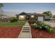 Charming home with solar panels, brick exterior, and inviting flower beds at 10478 Ogden St, Northglenn, CO 80233