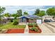 Charming brick home with solar panels, lush flower beds and manicured lawn at 10478 Ogden St, Northglenn, CO 80233