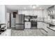 Modern kitchen with white cabinets, stainless steel appliances, and sleek countertops at 10478 Ogden St, Northglenn, CO 80233