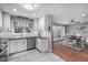 Bright eat-in kitchen featuring white cabinetry, granite countertops, and stainless steel appliances at 10478 Ogden St, Northglenn, CO 80233