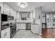 Updated kitchen with stainless steel appliances, white cabinets, and contemporary backsplash at 10478 Ogden St, Northglenn, CO 80233