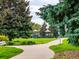 Serene park with lush greenery, mature trees, and playground equipment at 10478 Ogden St, Northglenn, CO 80233
