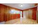 Finished basement area with wood paneling and built-in shelving at 1935 Nome St, Aurora, CO 80010