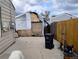 Backyard featuring a damaged shed, trash can, and wood fence at 1242 S Seneca Way, Denver, CO 80223
