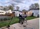 Spacious backyard featuring a barbecue grill on a concrete patio, shed, and fenced perimeter at 1242 S Seneca Way, Denver, CO 80223