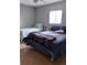 Bright bedroom with two beds, hardwood floors, grey walls, and a ceiling fan at 1242 S Seneca Way, Denver, CO 80223