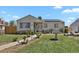 Charming single-story home with a stone accent wall, solar panels, and a well-manicured front yard at 1242 S Seneca Way, Denver, CO 80223