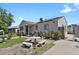Charming home featuring a stone-accented porch, solar panels, and a delightful picnic area in the front yard at 1242 S Seneca Way, Denver, CO 80223