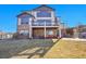 Two-story home featuring a deck and outdoor seating area, set in a well-maintained backyard at 8726 Gardenia Cir, Arvada, CO 80005