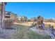 Landscaped backyard featuring a wooden playset and a spacious grassy area, ideal for outdoor activities and relaxation at 8726 Gardenia Cir, Arvada, CO 80005