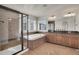 Gorgeous primary bathroom featuring a double vanity, soaking tub, and sleek glass-enclosed shower at 8726 Gardenia Cir, Arvada, CO 80005