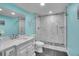 Stylish bathroom with a modern vanity, glass shower enclosure, and sleek fixtures at 8726 Gardenia Cir, Arvada, CO 80005