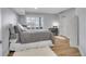 Comfortable bedroom featuring a large window, wood floors, and neutral decor at 8726 Gardenia Cir, Arvada, CO 80005
