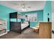 bedroom with bright turquoise walls, a ceiling fan, bunk beds, and window with shutter blinds at 8726 Gardenia Cir, Arvada, CO 80005