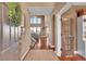Welcoming entryway with hardwood floors, a large mirror, and an open view of the staircase and living area at 8726 Gardenia Cir, Arvada, CO 80005