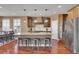 Well-appointed kitchen with a large island, granite countertops, and stainless steel appliances at 8726 Gardenia Cir, Arvada, CO 80005