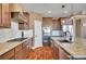 Modern kitchen featuring granite countertops, stainless steel appliances, and wood flooring at 8726 Gardenia Cir, Arvada, CO 80005