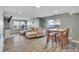 Spacious living room with hardwood floors, a comfortable sectional sofa, and natural light at 8726 Gardenia Cir, Arvada, CO 80005
