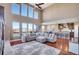 Spacious living room featuring high ceilings, large windows, and an open layout to the kitchen at 8726 Gardenia Cir, Arvada, CO 80005