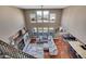 Open living space with a fireplace, windows with mountain views, kitchen, and dining area at 8726 Gardenia Cir, Arvada, CO 80005