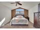 A spacious bedroom with vaulted ceiling, two end tables, and a large bed at 8726 Gardenia Cir, Arvada, CO 80005