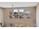 Upper level view through large windows with mountain and neighborhood views at 8726 Gardenia Cir, Arvada, CO 80005