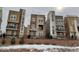 Modern townhomes boast contemporary designs, accented by stone and varying color schemes at 2617 Channel Dr, Highlands Ranch, CO 80129